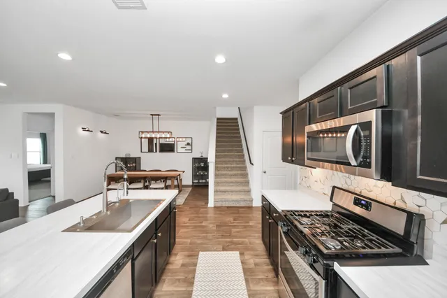 a view of a dining room with furniture and wooden floor