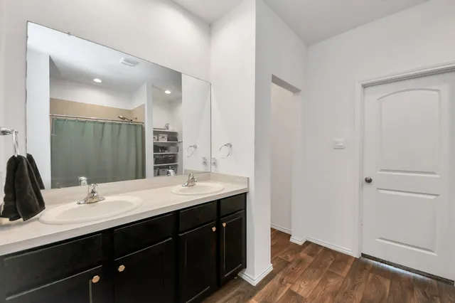 a view of bedroom with walk in closet and bathroom