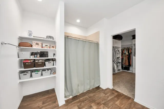 a spacious bathroom with a sink and a mirror