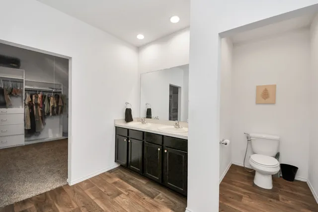 a living room with a bed furniture and a chandelier