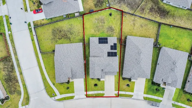 an aerial view of a house with a swimming pool