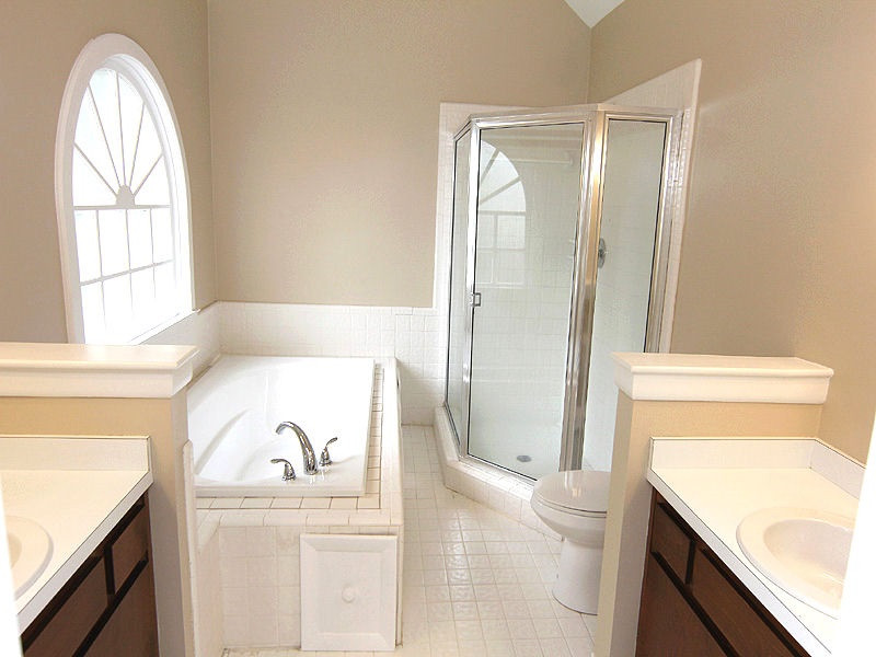 8333 Apple Orchard Way Raleigh, NC 27615 - Photo 16 of 25 Master bath with vaulted ceiling, new soaking tub and large ceramic shower. New light fixtures and mirrors.