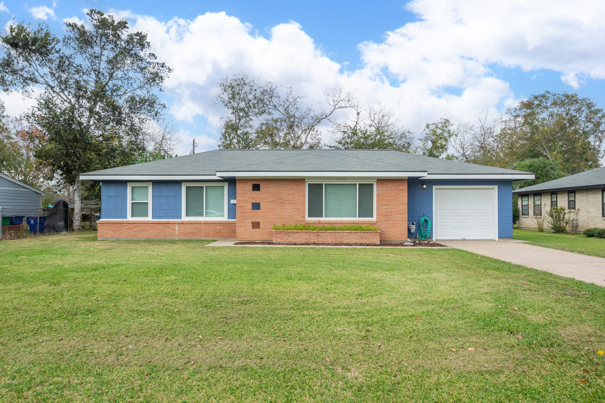 front view of a house and a yard with green space