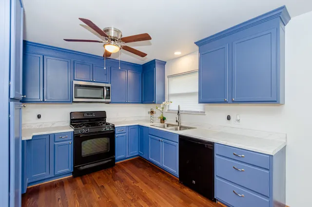 a kitchen with wooden cabinets and stainless steel appliances