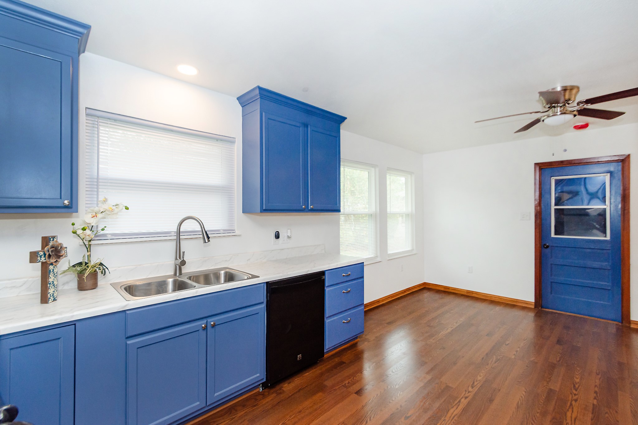 1007 Earley Street Sweeny, TX 77480 - Photo 12 of 33 a kitchen with wooden floors and wooden cabinets