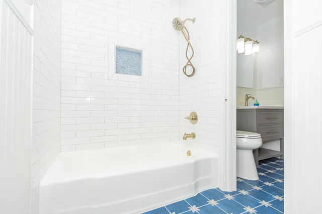 a bathroom with a bathtub and toilet