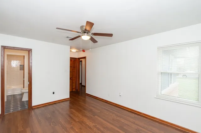 a view of room with wooden floor and ceiling fan