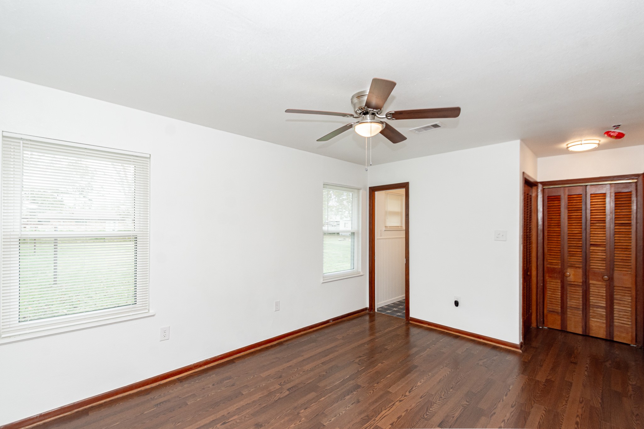 1007 Earley Street Sweeny, TX 77480 - Photo 21 of 33 a view of a livingroom with wooden floor and a ceiling fan