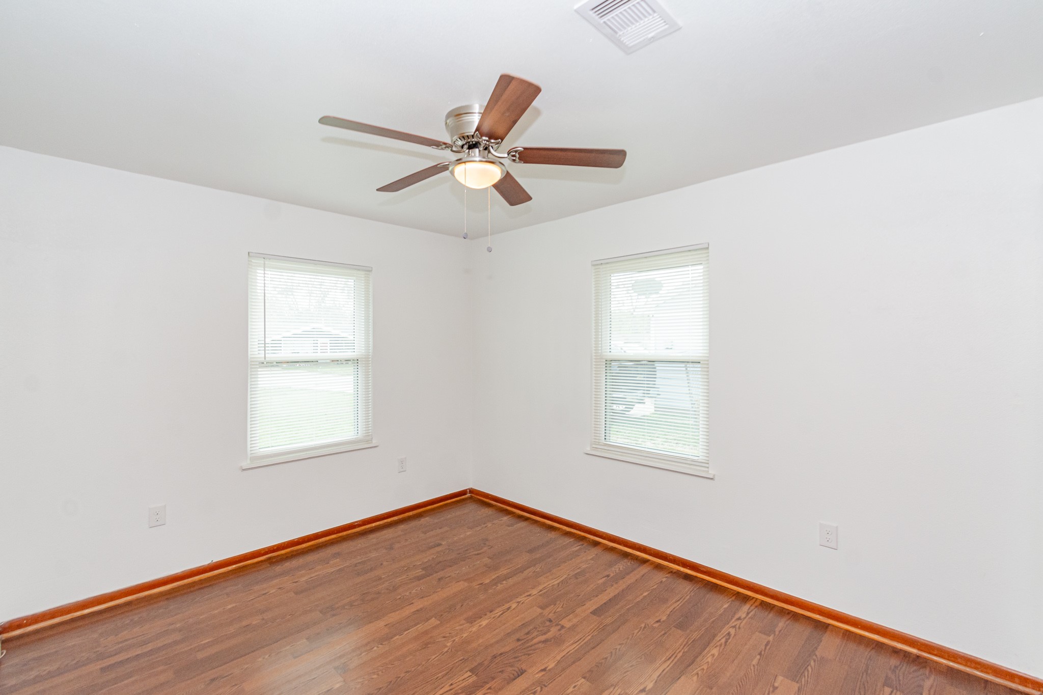 1007 Earley Street Sweeny, TX 77480 - Photo 22 of 33 a view of empty room with wooden floor and fan