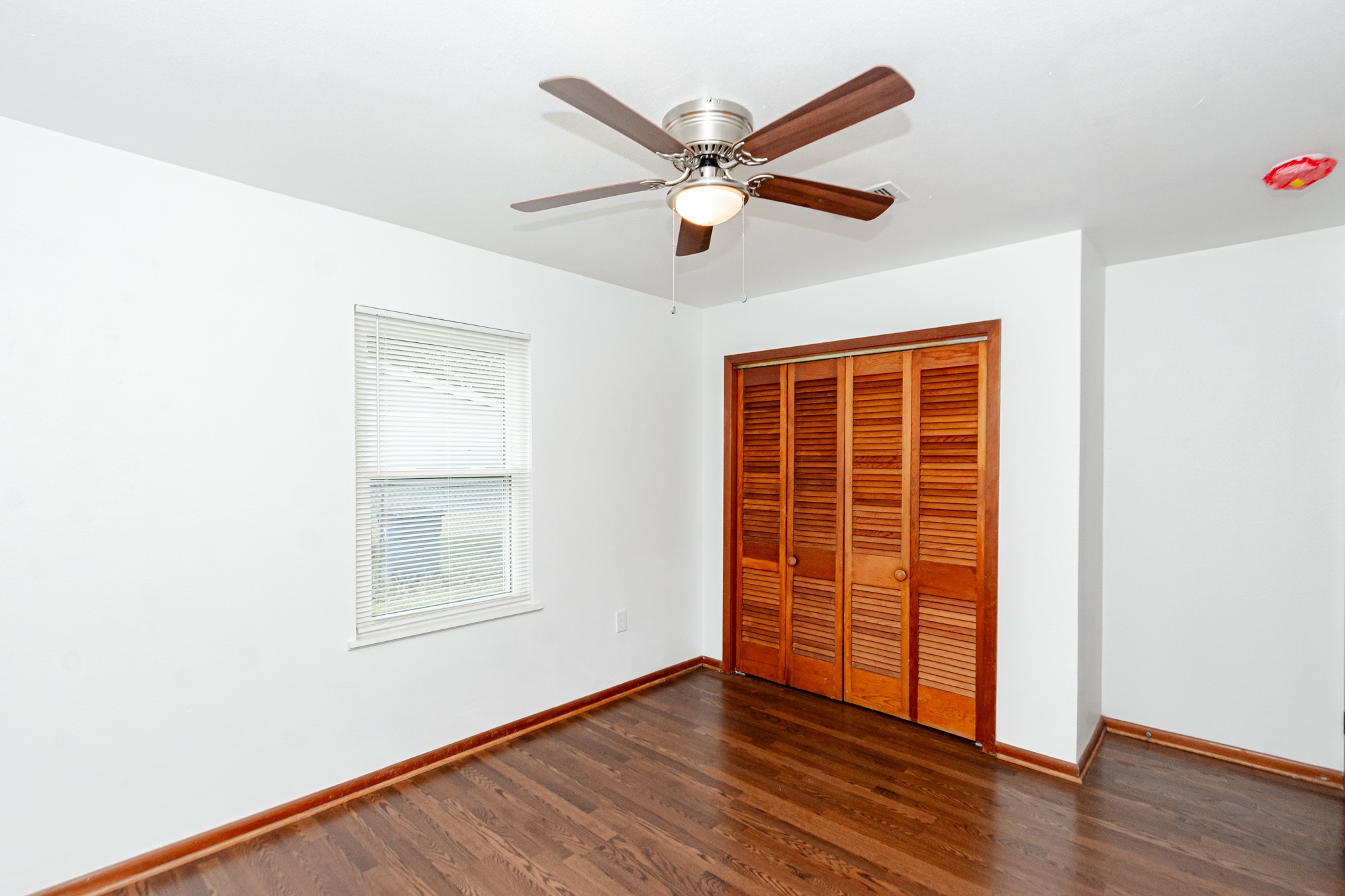 1007 Earley Street Sweeny, TX 77480 - Photo 23 of 33 an empty room with wooden floor closet and windows