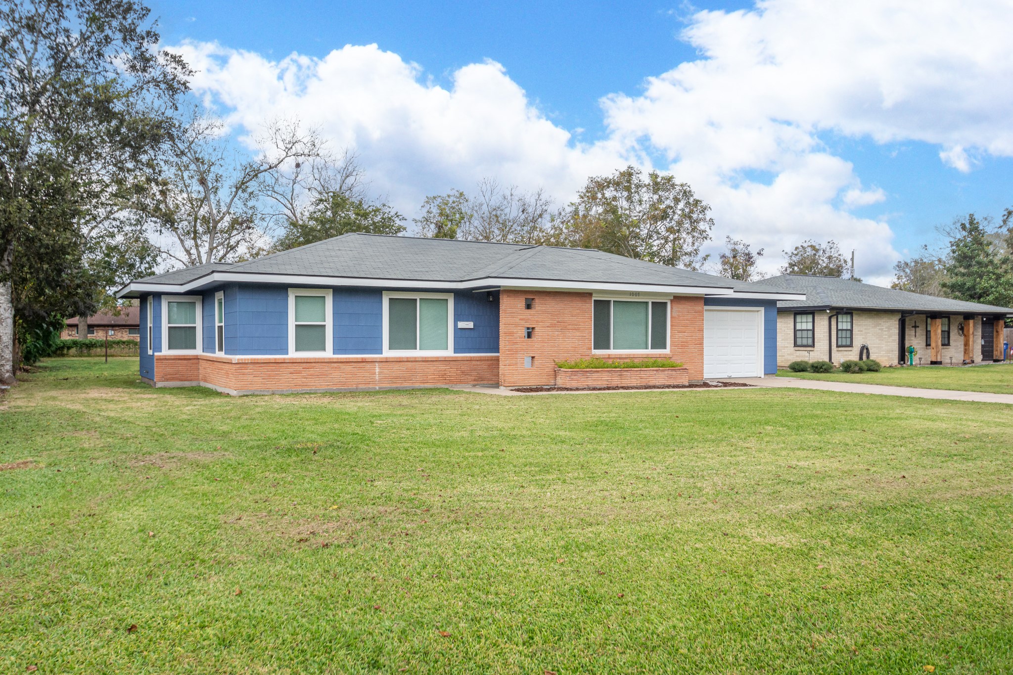 1007 Earley Street Sweeny, TX 77480 - Photo 4 of 33 a view of a yard in front of a house with large trees