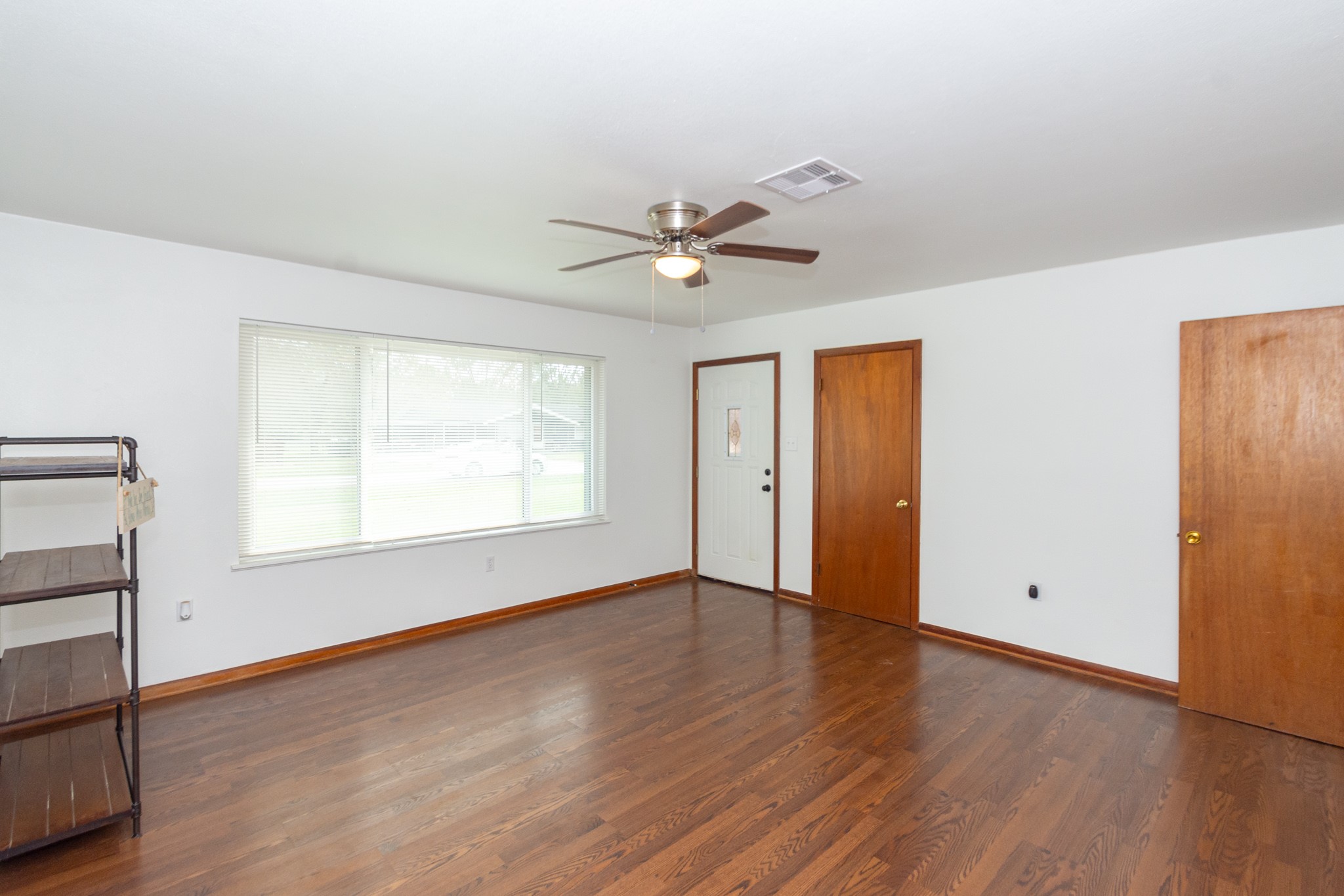 1007 Earley Street Sweeny, TX 77480 - Photo 5 of 33 an empty room with wooden floor and windows