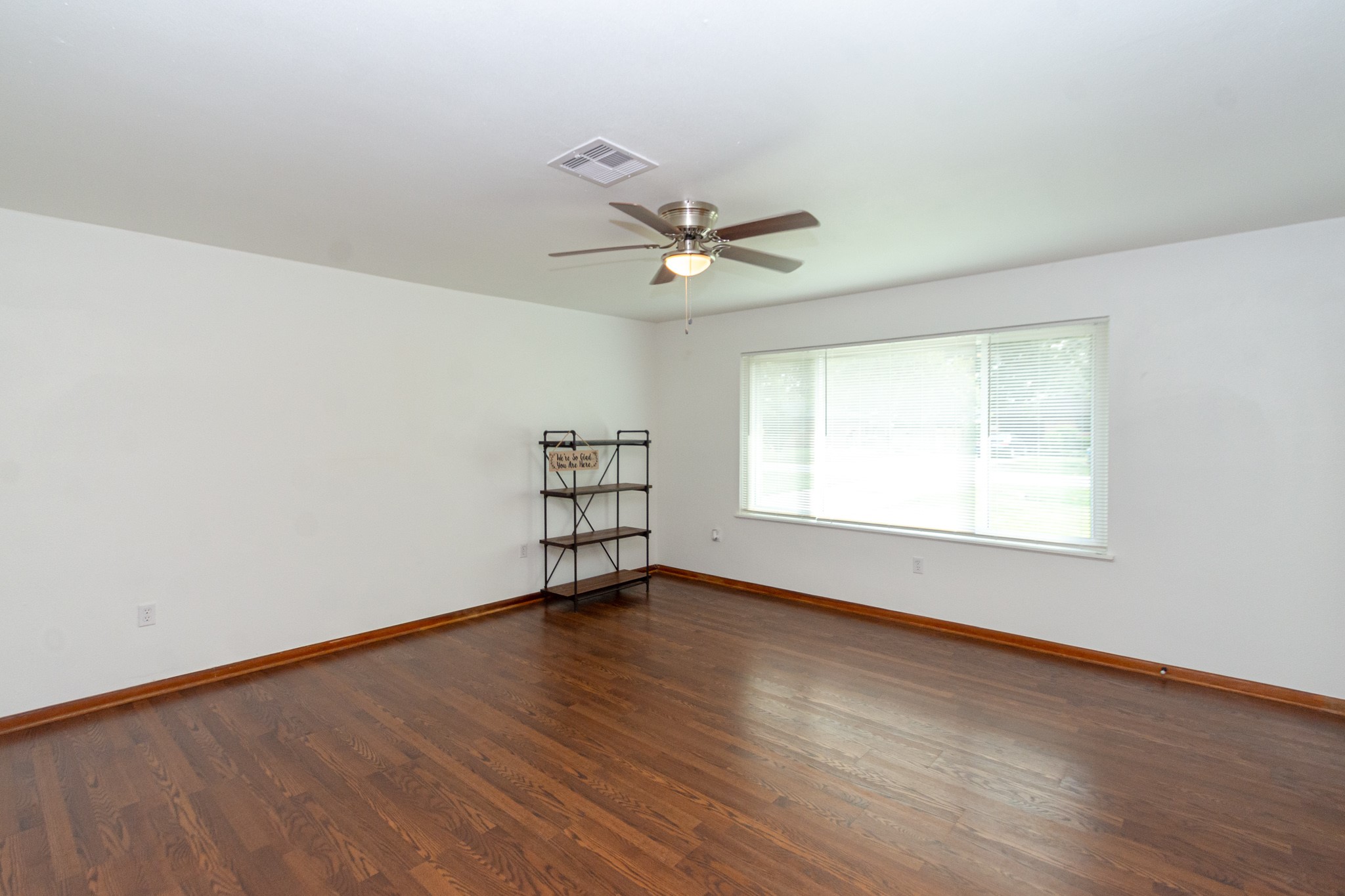 1007 Earley Street Sweeny, TX 77480 - Photo 6 of 33 an empty room with wooden floor and windows