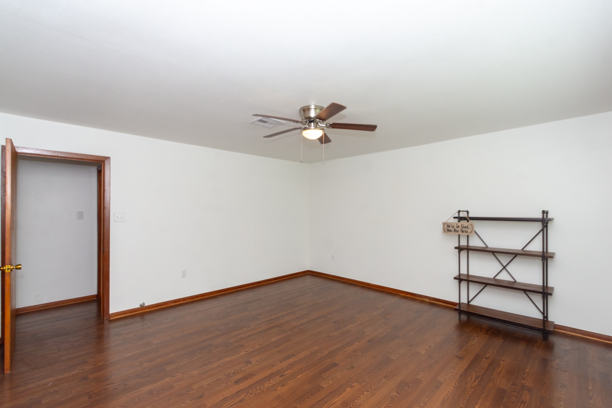 1007 Earley Street Sweeny, TX 77480 - Photo 7 of 33 a view of a room with wooden floor and a ceiling fan