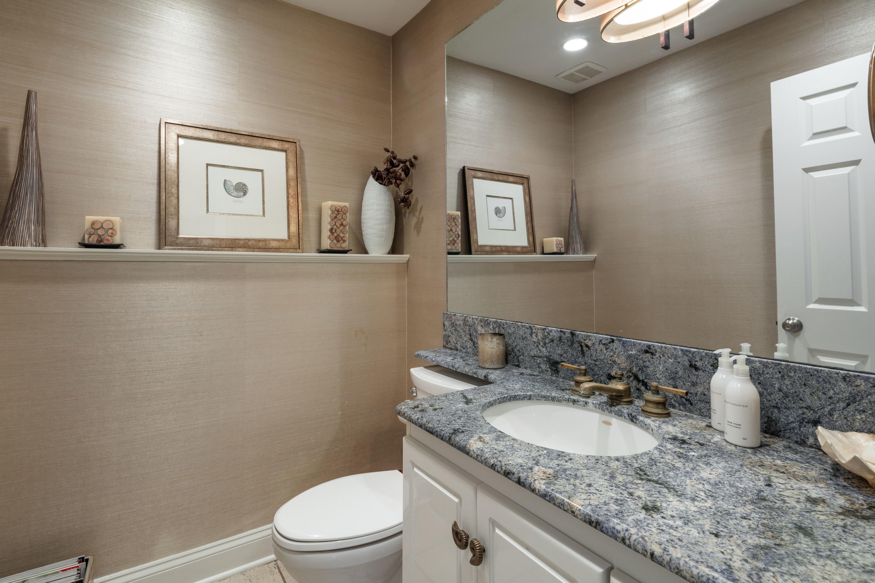 23 Waverly Road Darien, CT 06820 - Photo 17 of 28 a bathroom with a granite countertop sink and a mirror