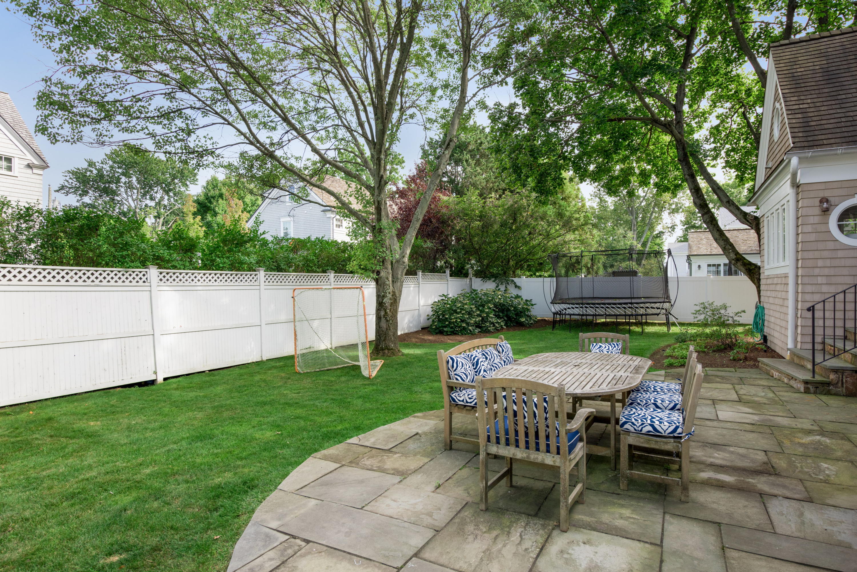 23 Waverly Road Darien, CT 06820 - Photo 4 of 28 a view of a patio with a table chairs and a fire pit