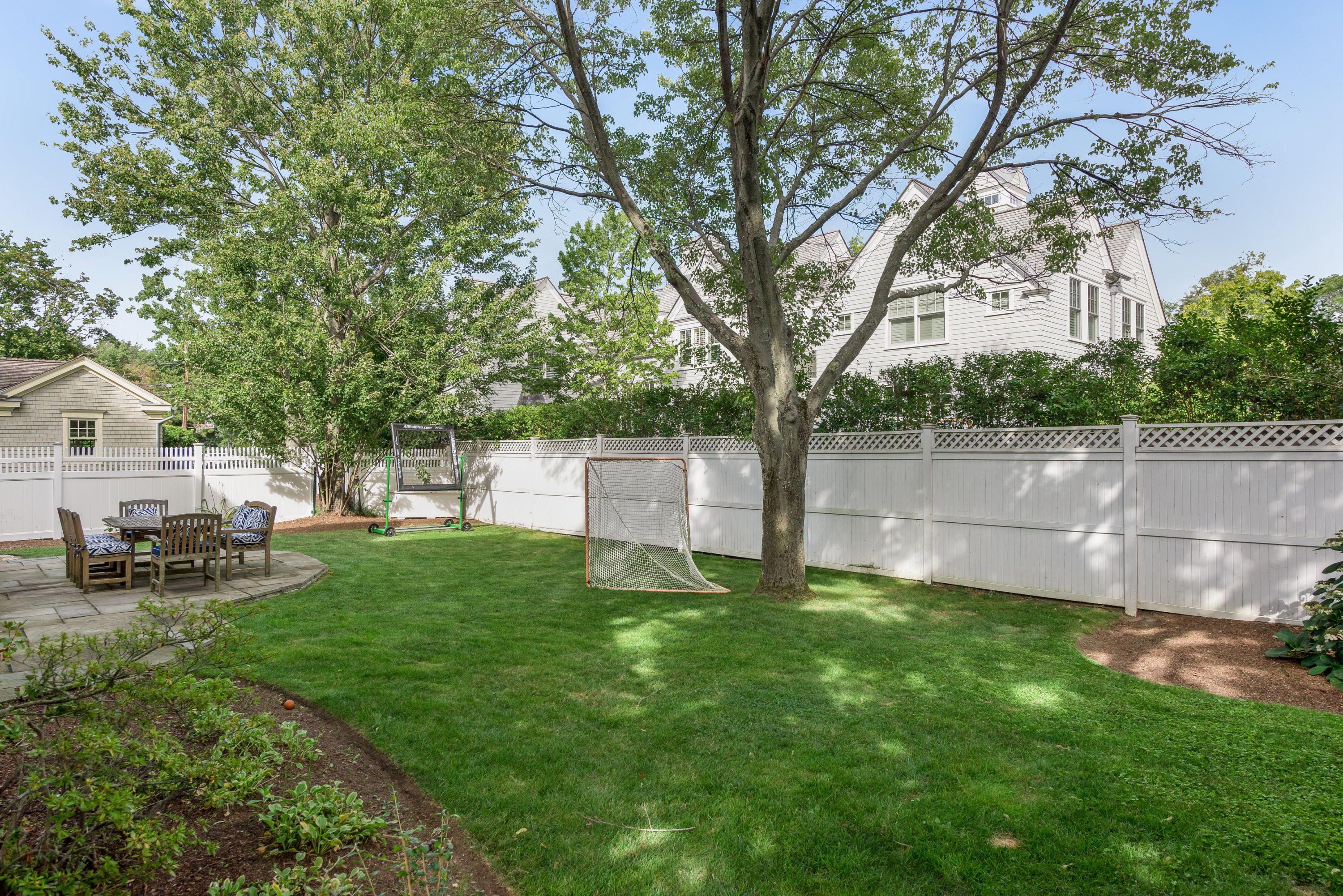 23 Waverly Road Darien, CT 06820 - Photo 5 of 28 a view of backyard with table and chairs and wooden fence