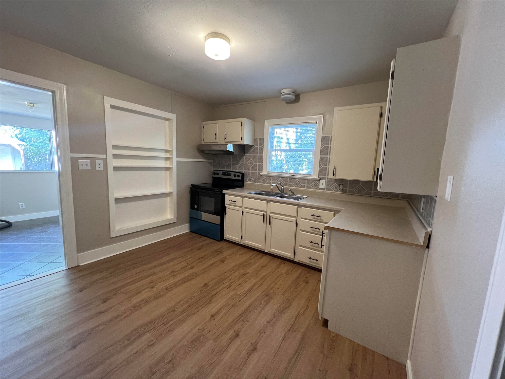 613 Koehl Street Wharton, TX 77488 - Photo 2 of 10 a kitchen with a sink stove and refrigerator