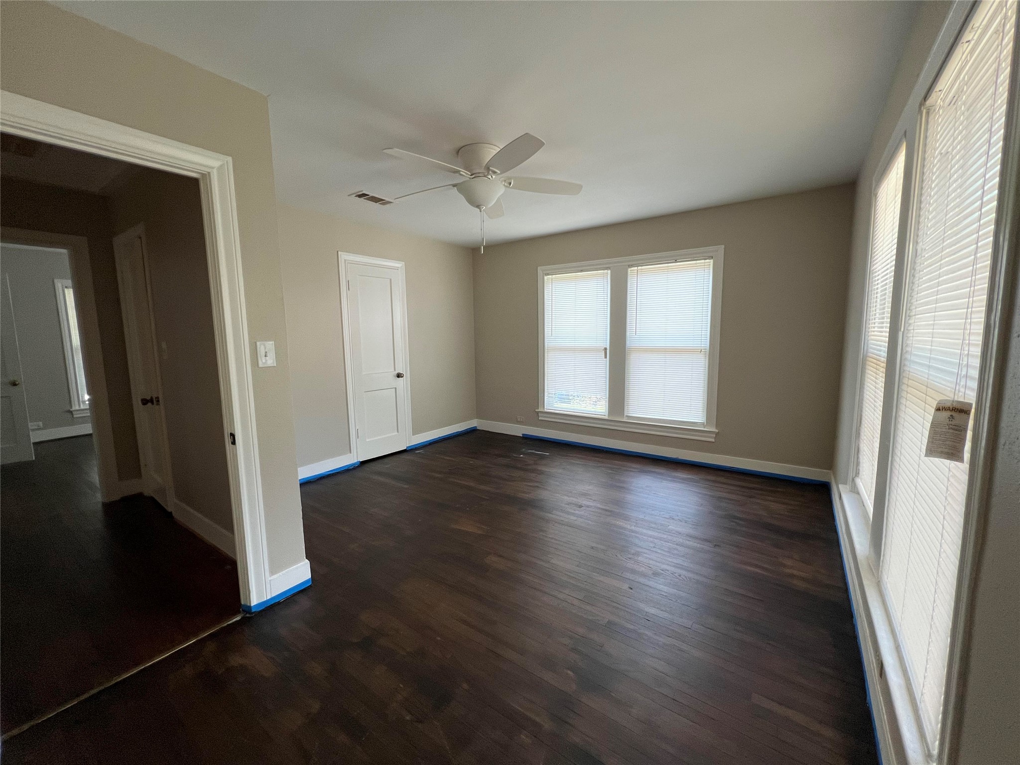 613 Koehl Street Wharton, TX 77488 - Photo 7 of 10 an empty room with wooden floor and windows