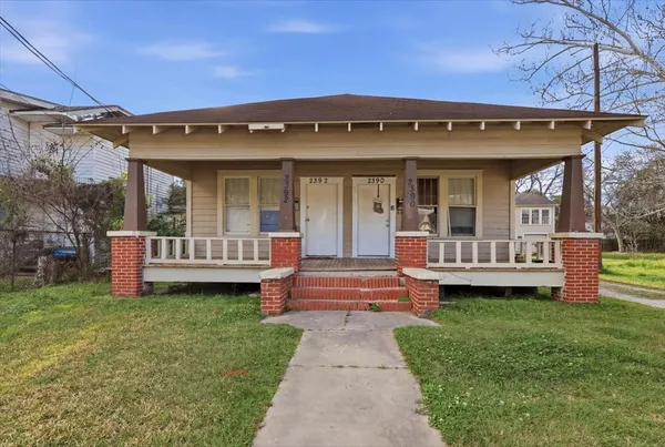 a view of a house with a yard and sitting area