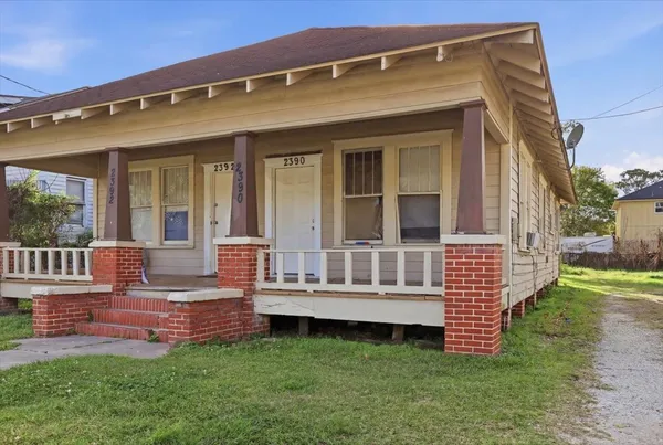 a view of a house with a yard and deck