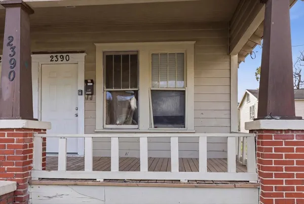 a view of a small house with a yard