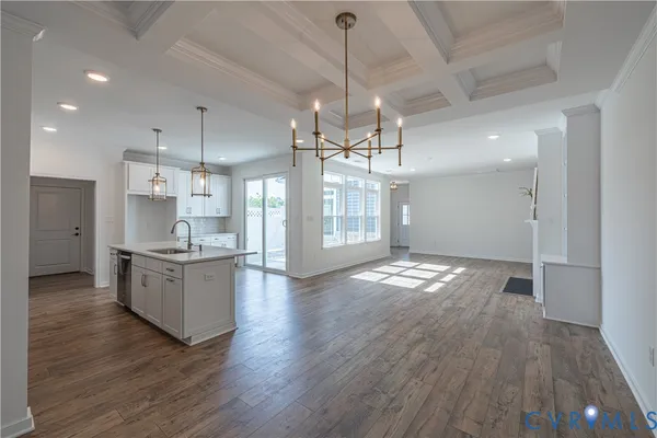 a large kitchen with granite countertop a large counter top appliances and cabinets