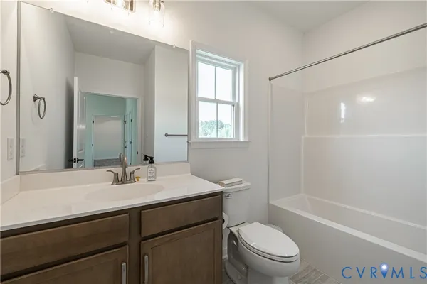 a bathroom with a sink a toilet a mirror and shower