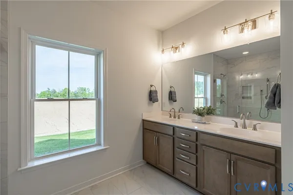 a bathroom with a double vanity sink and mirror with window