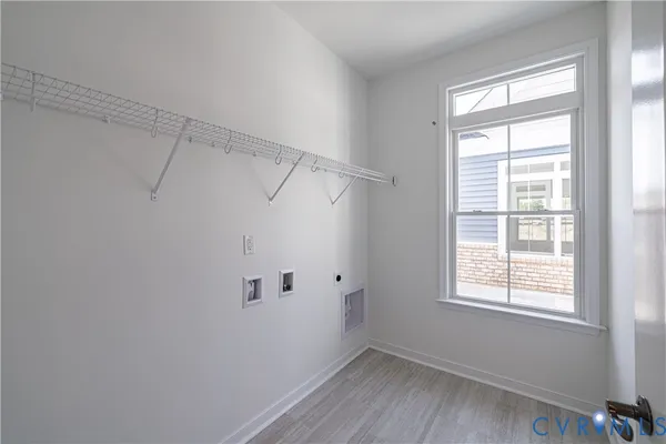 a view of a room with window and hardwood floor
