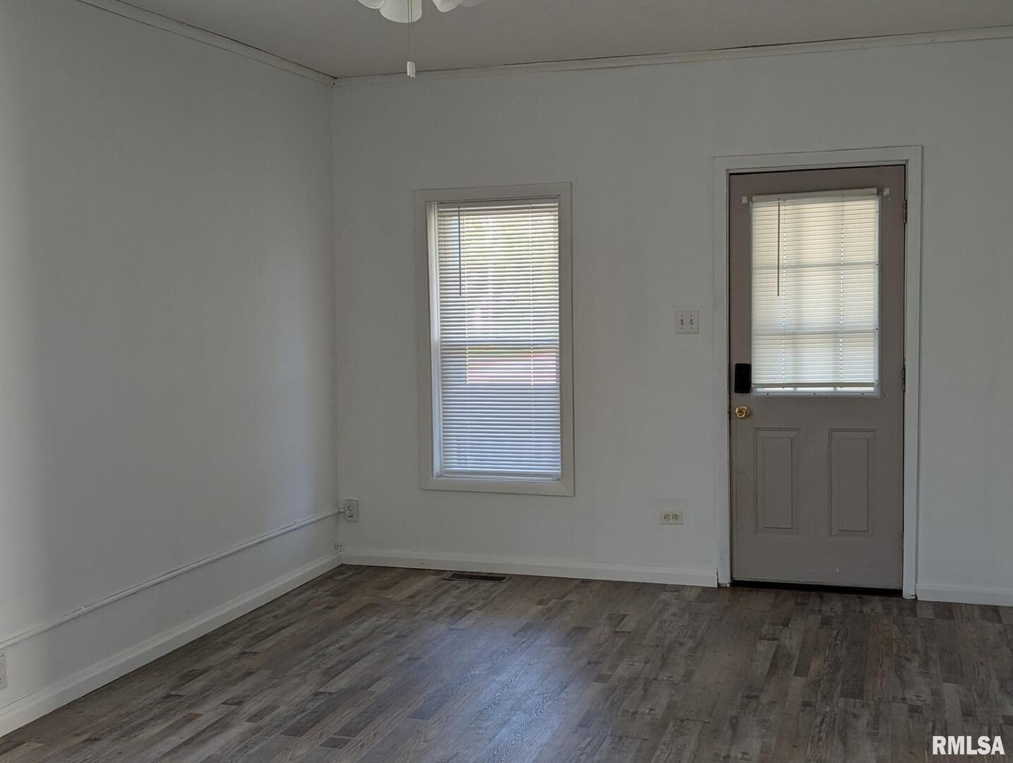 405 South State Street Christopher, IL 62822 - Photo 2 of 18 an empty room with wooden floor and windows