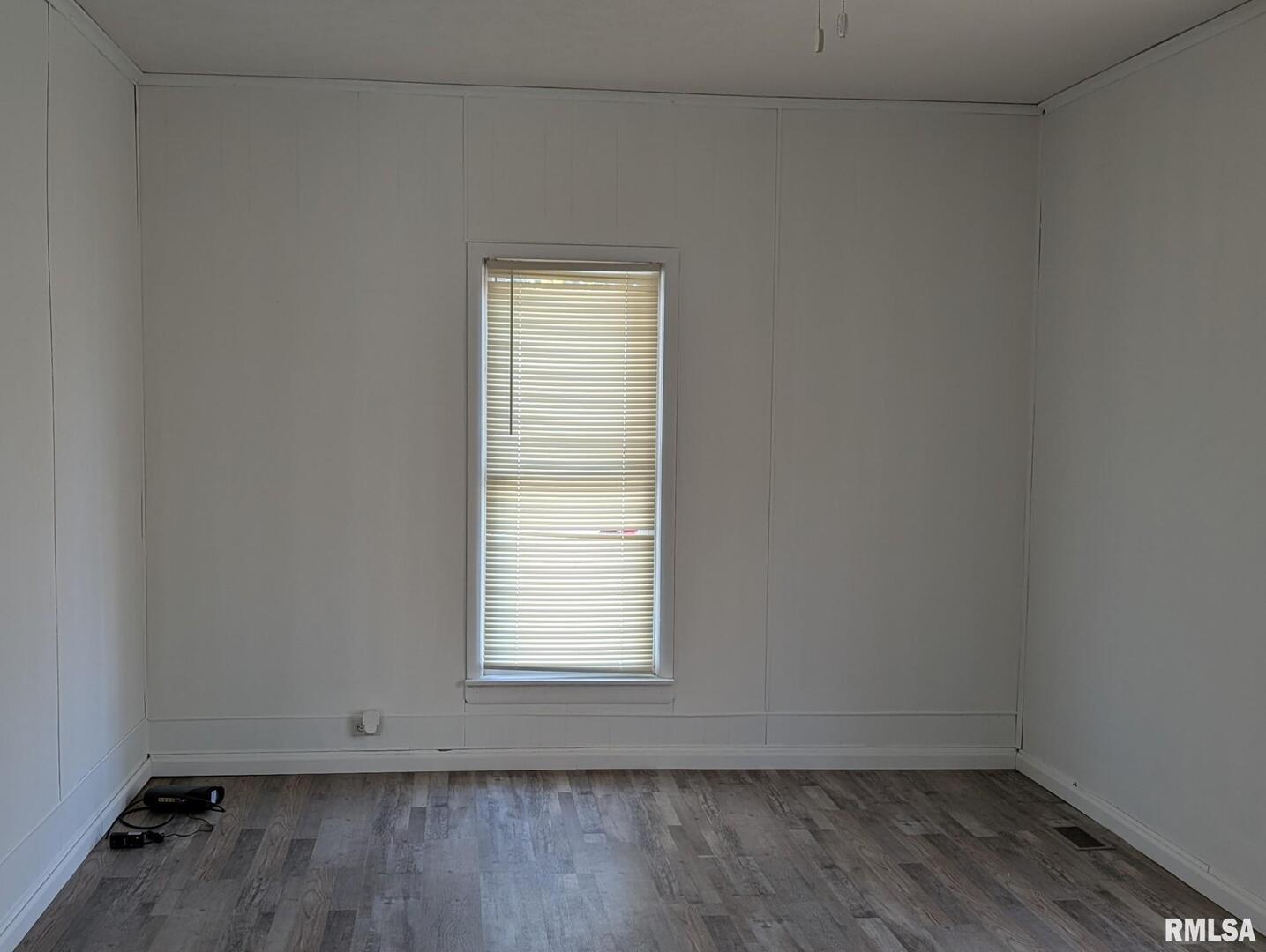 405 South State Street Christopher, IL 62822 - Photo 3 of 18 an empty room with wooden floor and windows