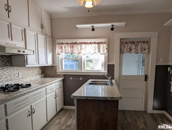 a kitchen with a sink stove and refrigerator