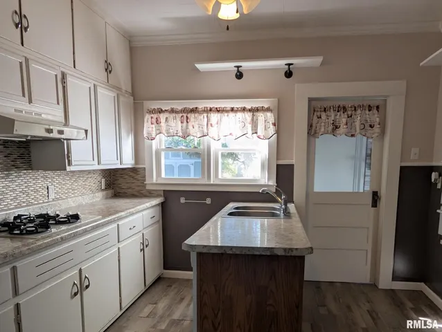 a kitchen with a sink stove and refrigerator