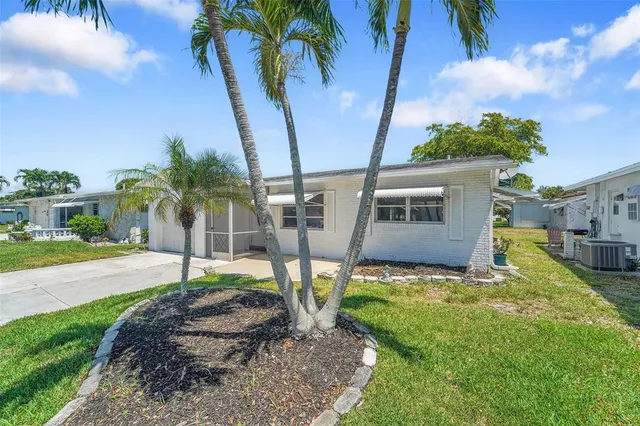 a view of a house with backyard and porch