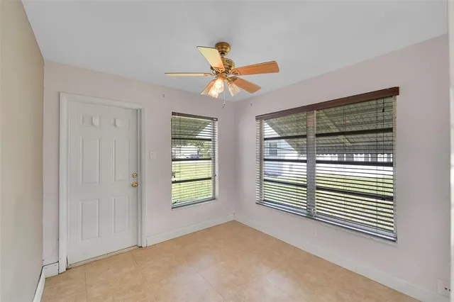 a view of a livingroom with a ceiling fan and window