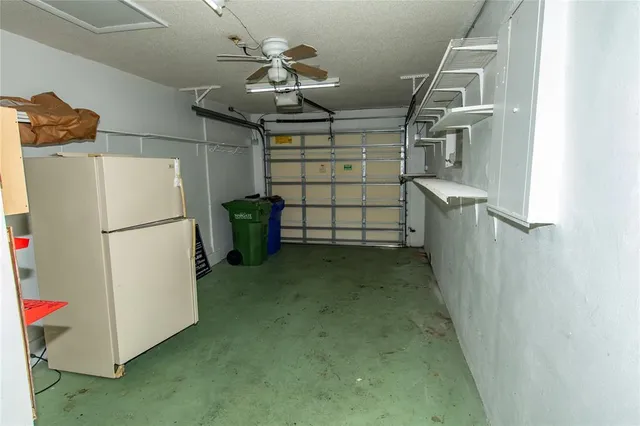 a view of storage and utility room with a refrigerator