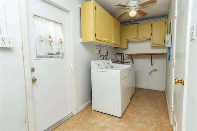 a utility room with cabinets washer and dryer