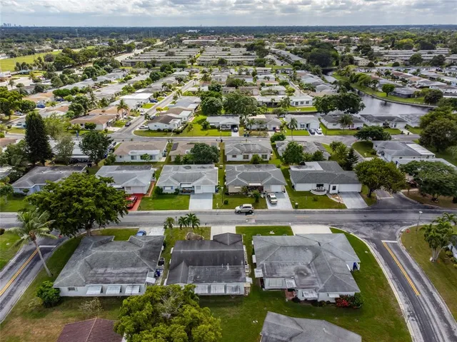 an aerial view of a house with a swimming pool yard and outdoor seating
