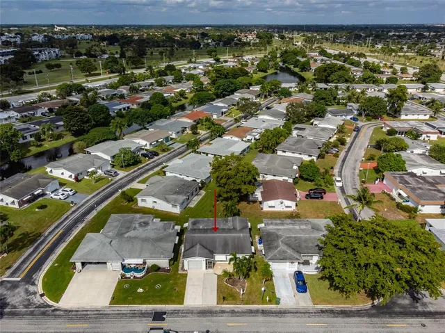 an aerial view of a residential houses with outdoor space