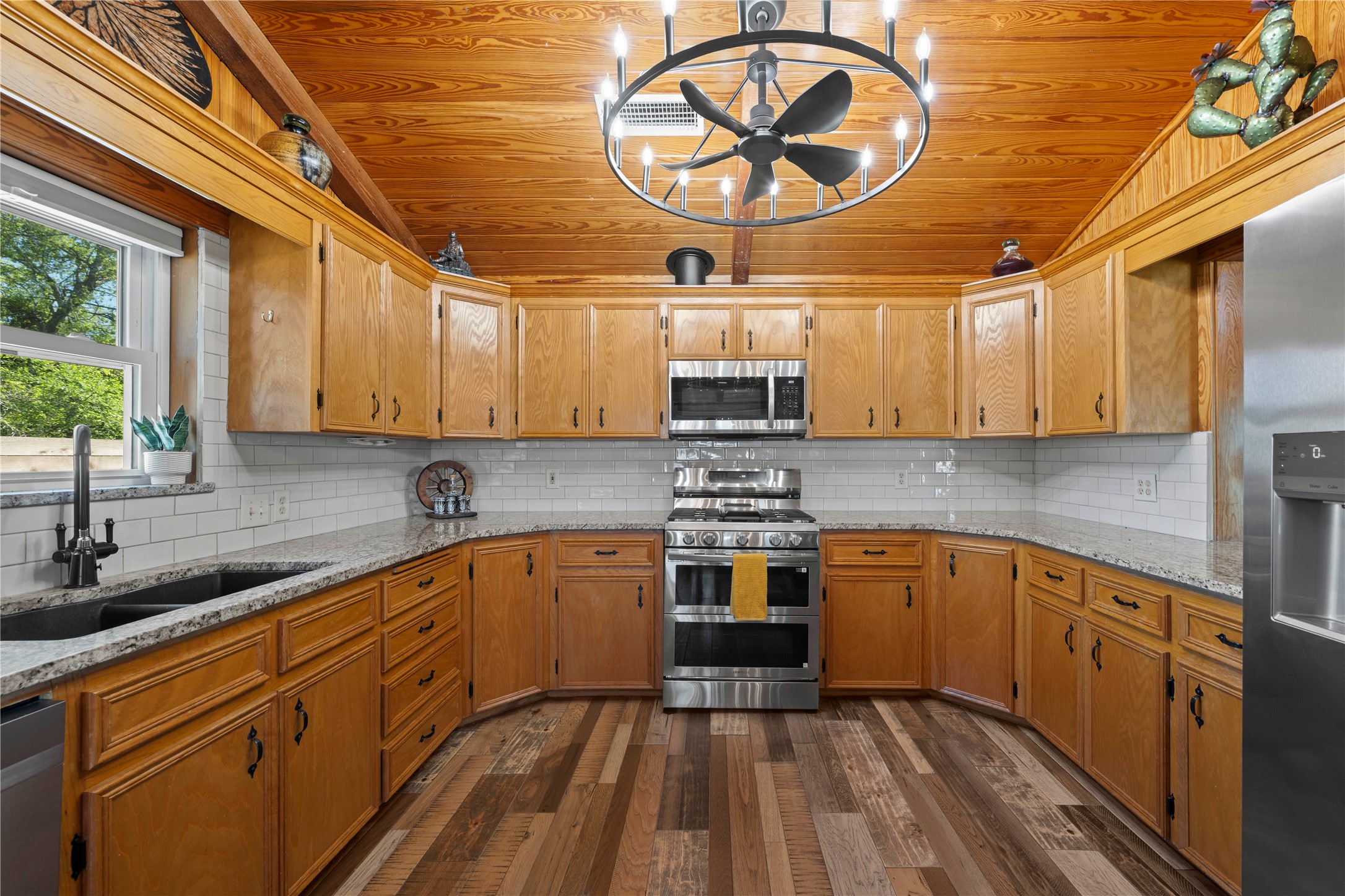 5597 Cliff Lane Temple, TX 76502 - Photo 13 of 38 a kitchen with stainless steel appliances granite countertop a sink a stove and cabinets