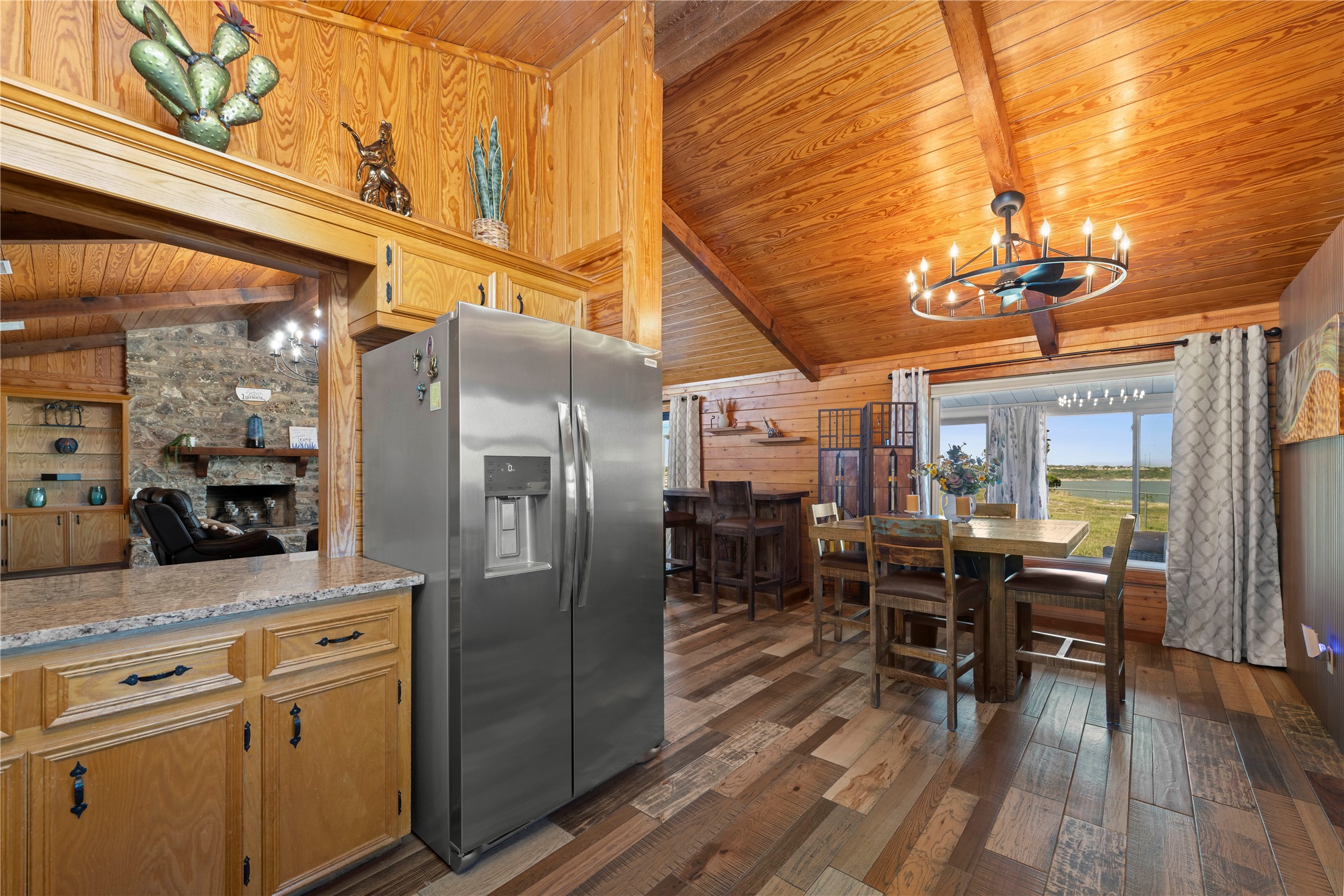 5597 Cliff Lane Temple, TX 76502 - Photo 14 of 38 a kitchen with stainless steel appliances a dining table chairs stove and refrigerator