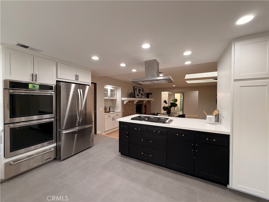 1677 South Hill Avenue Fallbrook, CA 92028 - Photo 22 of 74 a kitchen with kitchen island a counter top space stainless steel appliances and cabinets