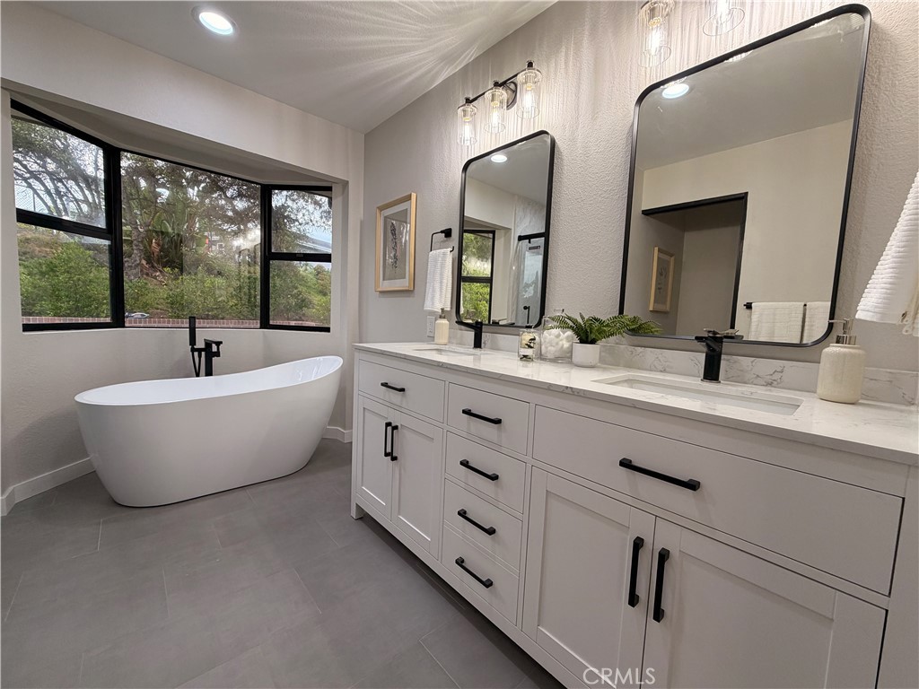 1677 South Hill Avenue Fallbrook, CA 92028 - Photo 48 of 74 a bathroom with a double vanity sink a large mirror and a window