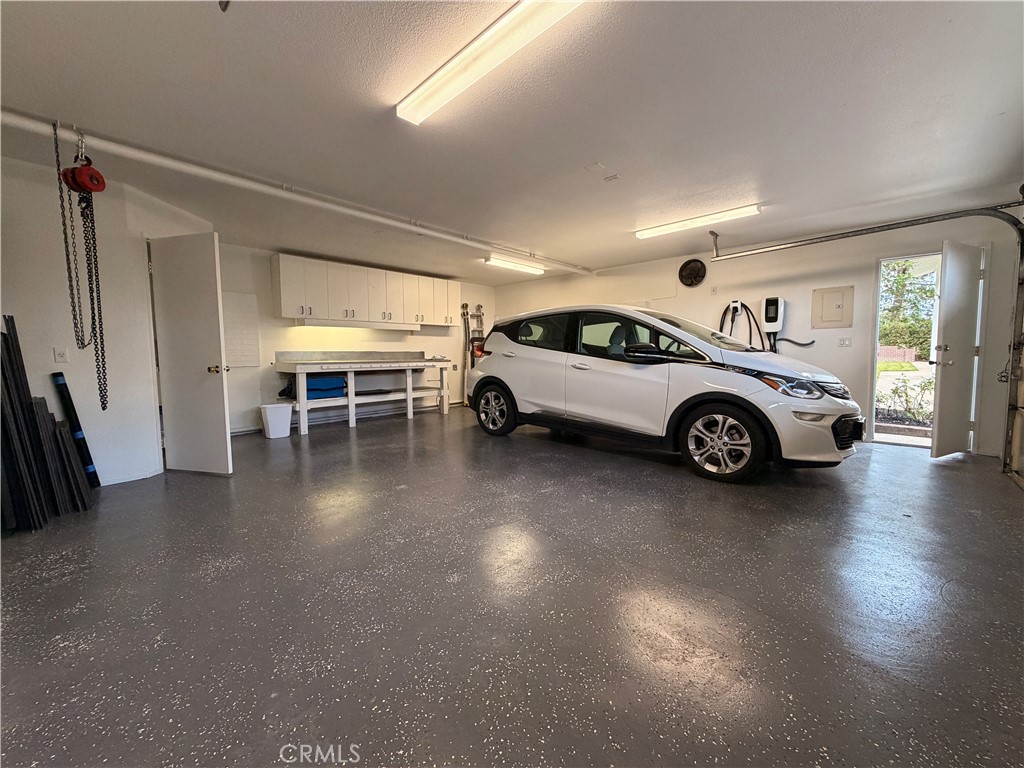 1677 South Hill Avenue Fallbrook, CA 92028 - Photo 70 of 74 Secondary garage/workshop with new epoxy floors, mechanics hoist, cabinets/bench, EV charger, half bathroom