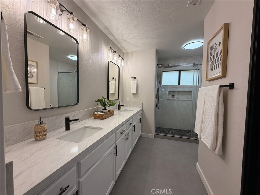 1677 South Hill Avenue Fallbrook, CA 92028 - Photo 10 of 74 a spacious bathroom with a double vanity sink and mirror