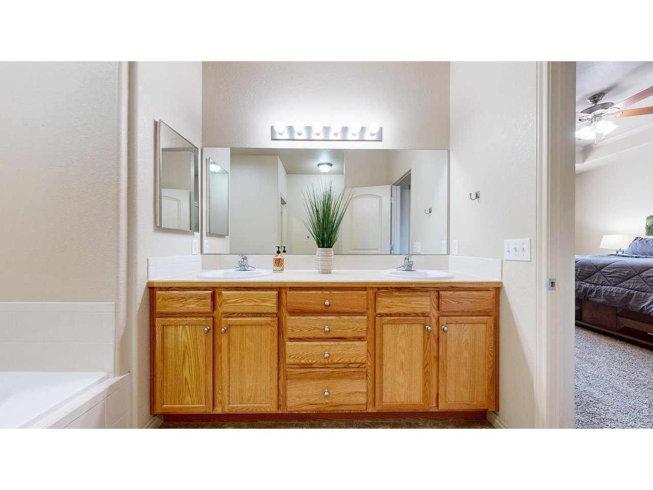 4672 West 20th Road, Unit 413 Greeley, CO 80634 - Photo 22 of 37 a bathroom with a sink a vanity and a mirror