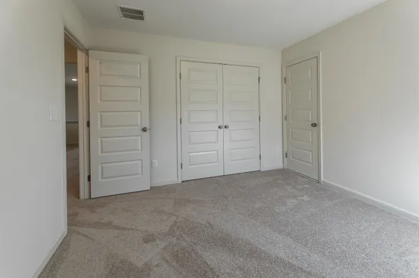 an empty room with closet area