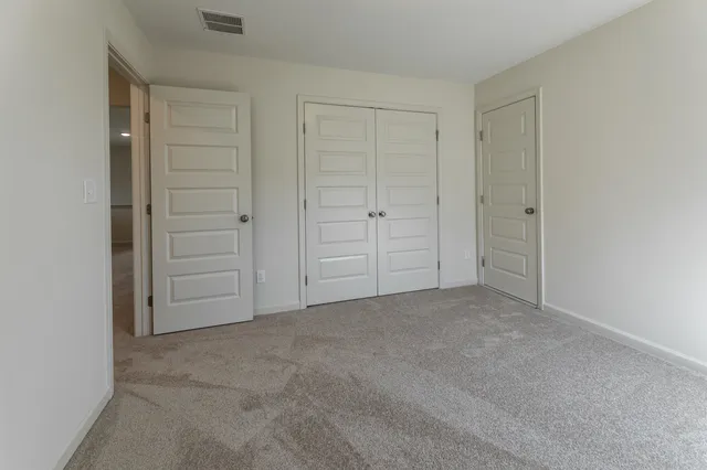 an empty room with closet area