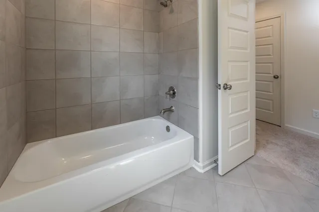 a bathroom with a bathtub and shower